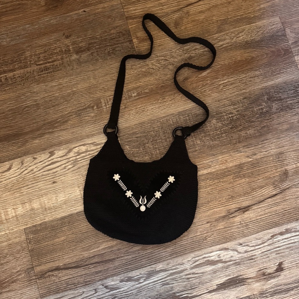Stylish Black Woven Crossbody Bag with White Floral Accents